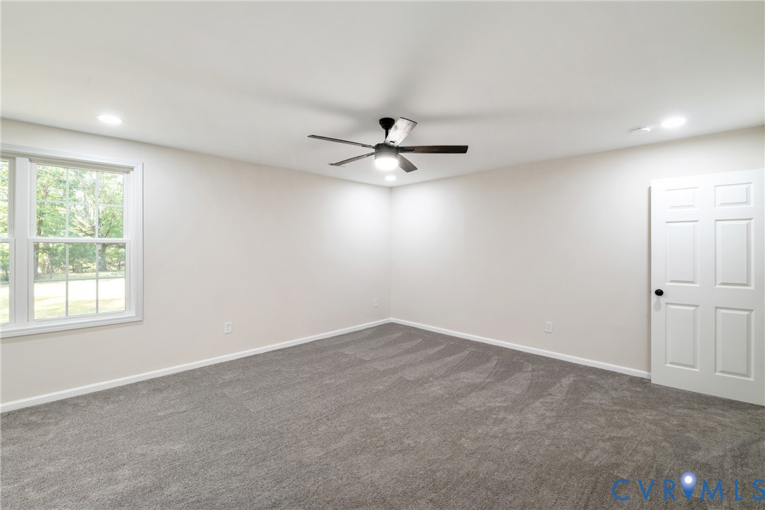 1531 Pughs Store Road Afton, VA 22920 - Photo 20 of 40 an empty room with windows and ceiling fan
