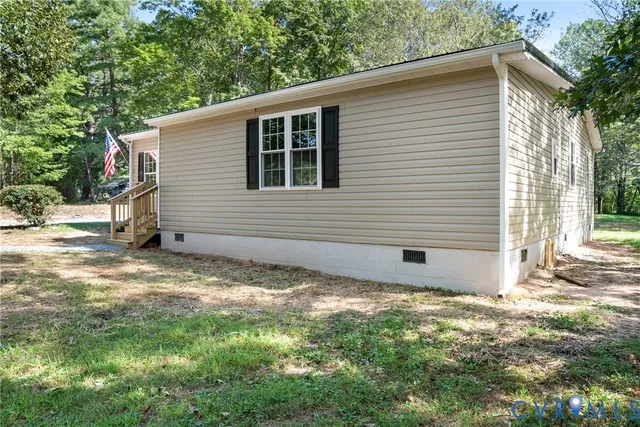 a backyard of a house with barbeque oven and outdoor seating