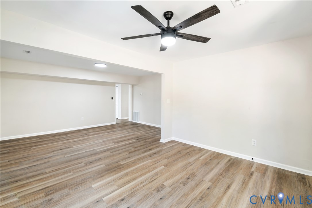 1531 Pughs Store Road Afton, VA 22920 - Photo 7 of 40 an empty room with wooden floor and a ceiling fan