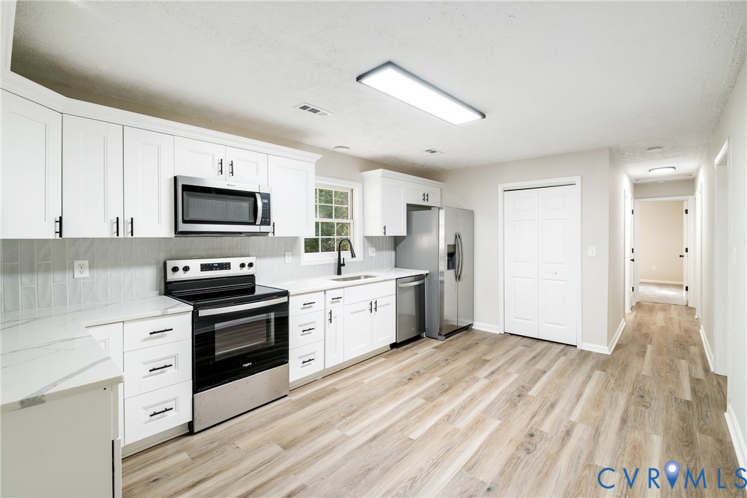 1531 Pughs Store Road Afton, VA 22920 - Photo 8 of 40 a kitchen with granite countertop a refrigerator stove top oven and sink