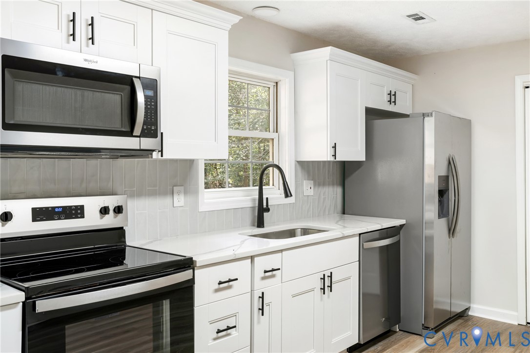 1531 Pughs Store Road Afton, VA 22920 - Photo 9 of 40 a kitchen with stainless steel appliances a stove microwave and sink