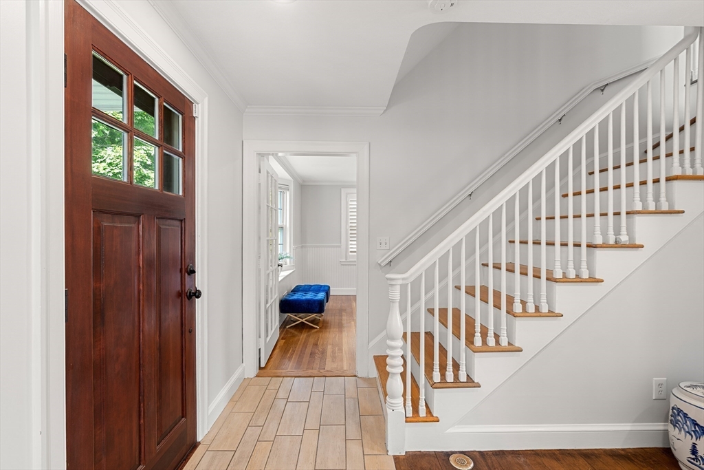 6 Shetland Road Marblehead, MA 01945 - Photo 3 of 39 a view of staircase with lots of frames on wall and a window