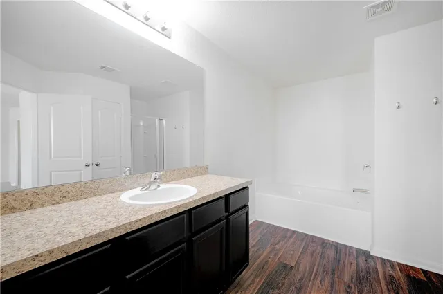 a bathroom with a granite countertop sink a mirror and a