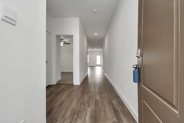 an empty room with closet and a chandelier fan