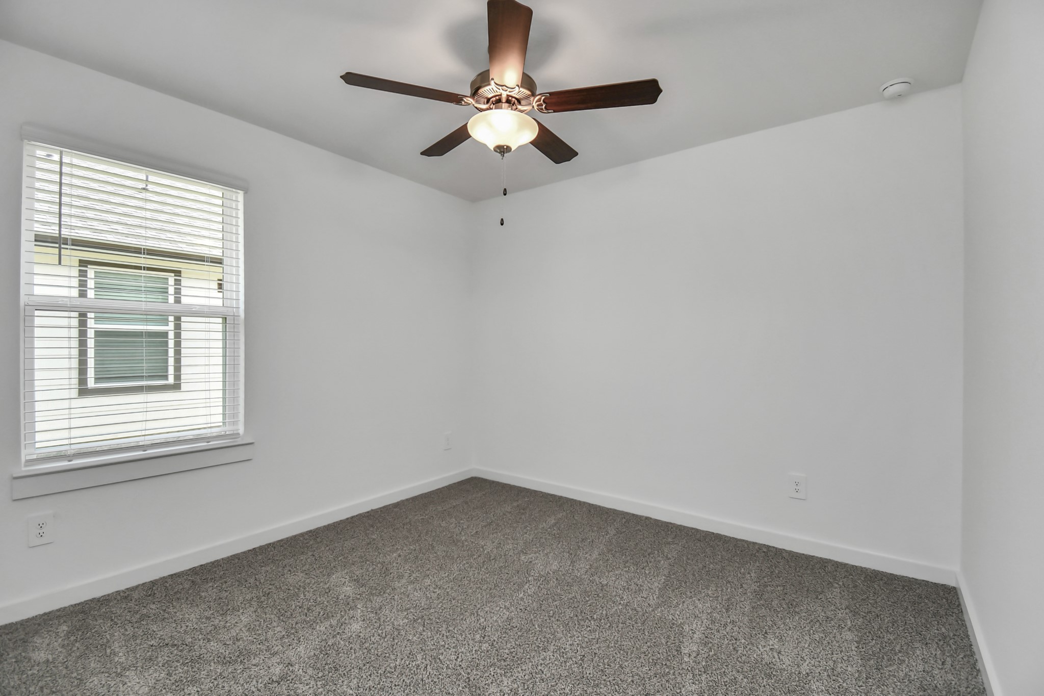 1110 Fringed Bluestar Drive Rosharon, TX 77583 - Photo 15 of 41 an empty room with a window and a fan
