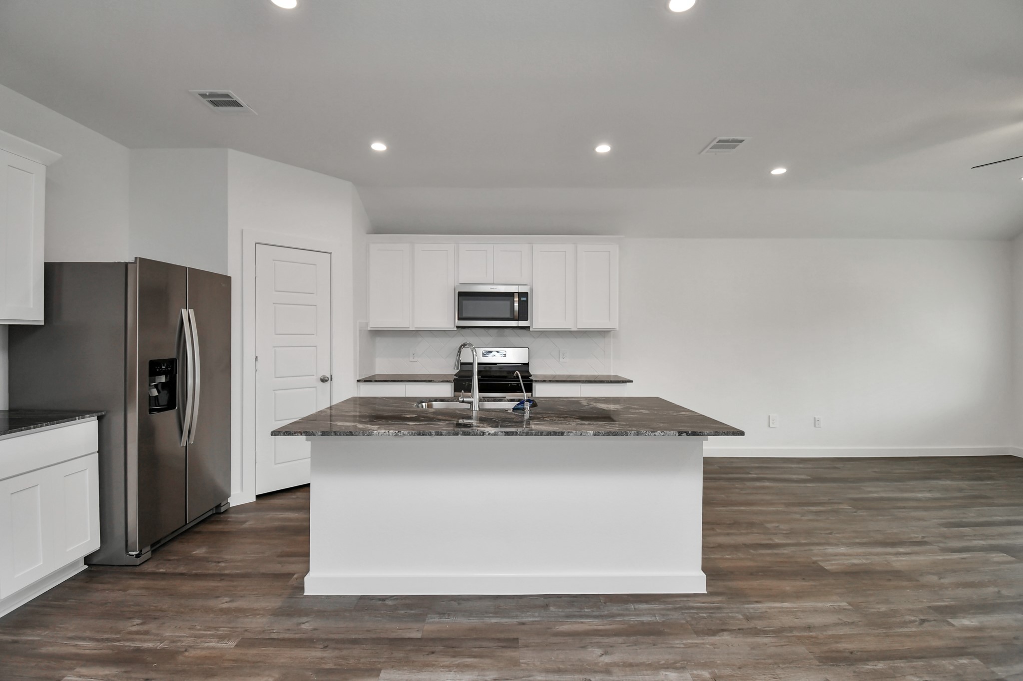 1110 Fringed Bluestar Drive Rosharon, TX 77583 - Photo 22 of 41 a kitchen with kitchen island stainless steel appliances a sink a stove a microwave and refrigerator