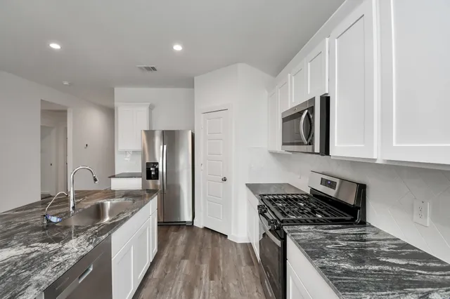 a kitchen with a stove and a sink