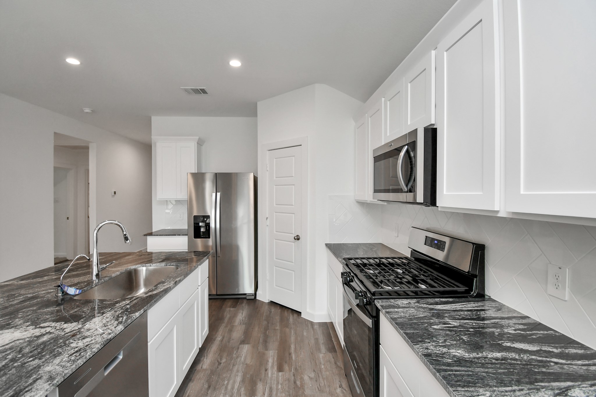 1110 Fringed Bluestar Drive Rosharon, TX 77583 - Photo 24 of 41 a kitchen with stainless steel appliances granite countertop a sink stove and refrigerator