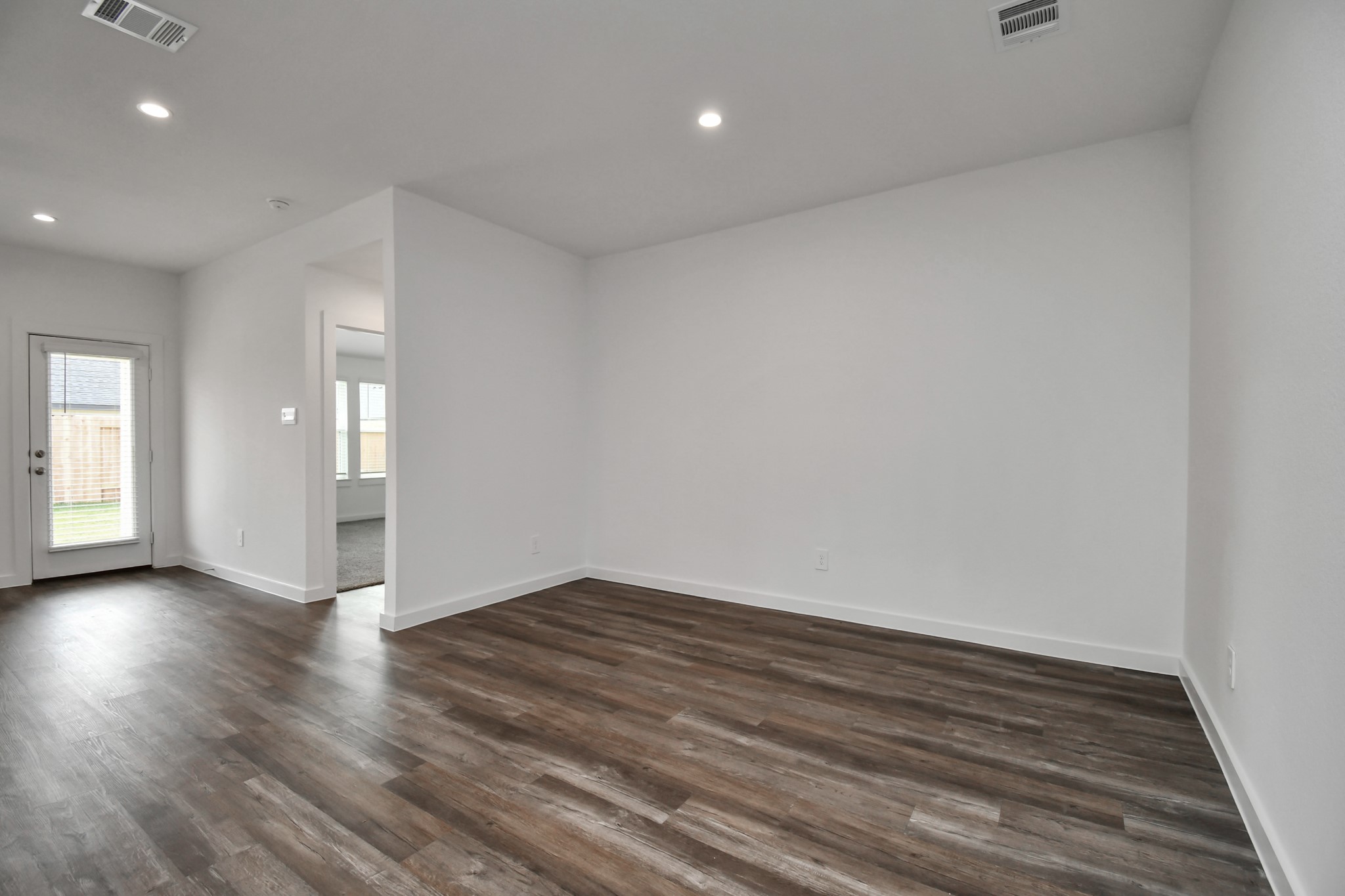 1110 Fringed Bluestar Drive Rosharon, TX 77583 - Photo 27 of 41 a view of an empty room with wooden floor and a window