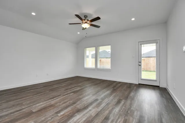 a view of a kitchen with wooden floor and a ceiling fan