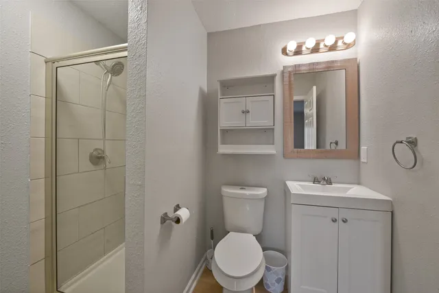a white toilet sitting next to a bathroom sink