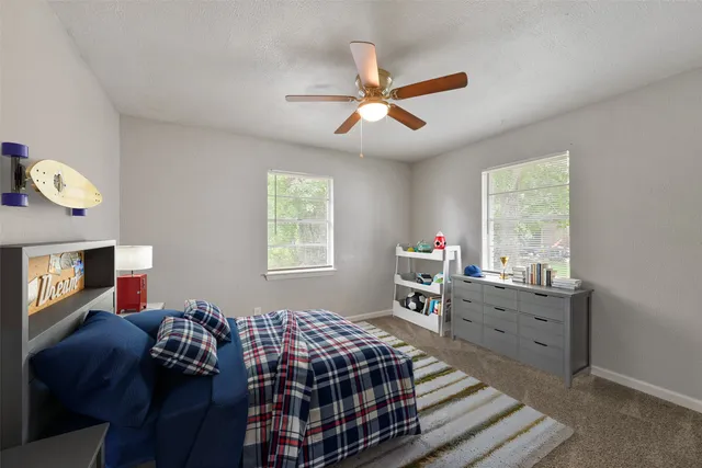 a bedroom that has a bed and a window