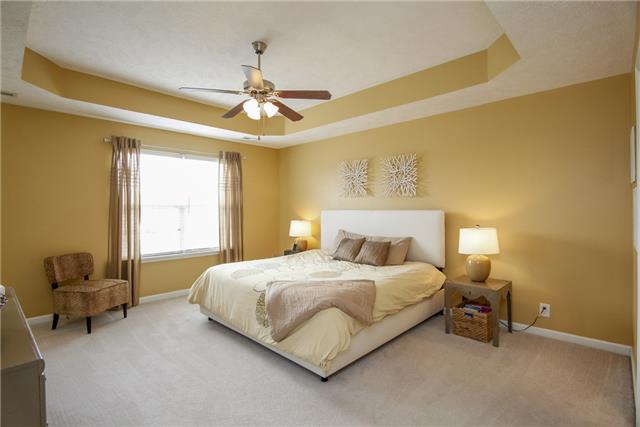 1042 Woodall Road Lebanon, TN 37090 - Photo 9 of 16 a bedroom with a bed and a chandelier