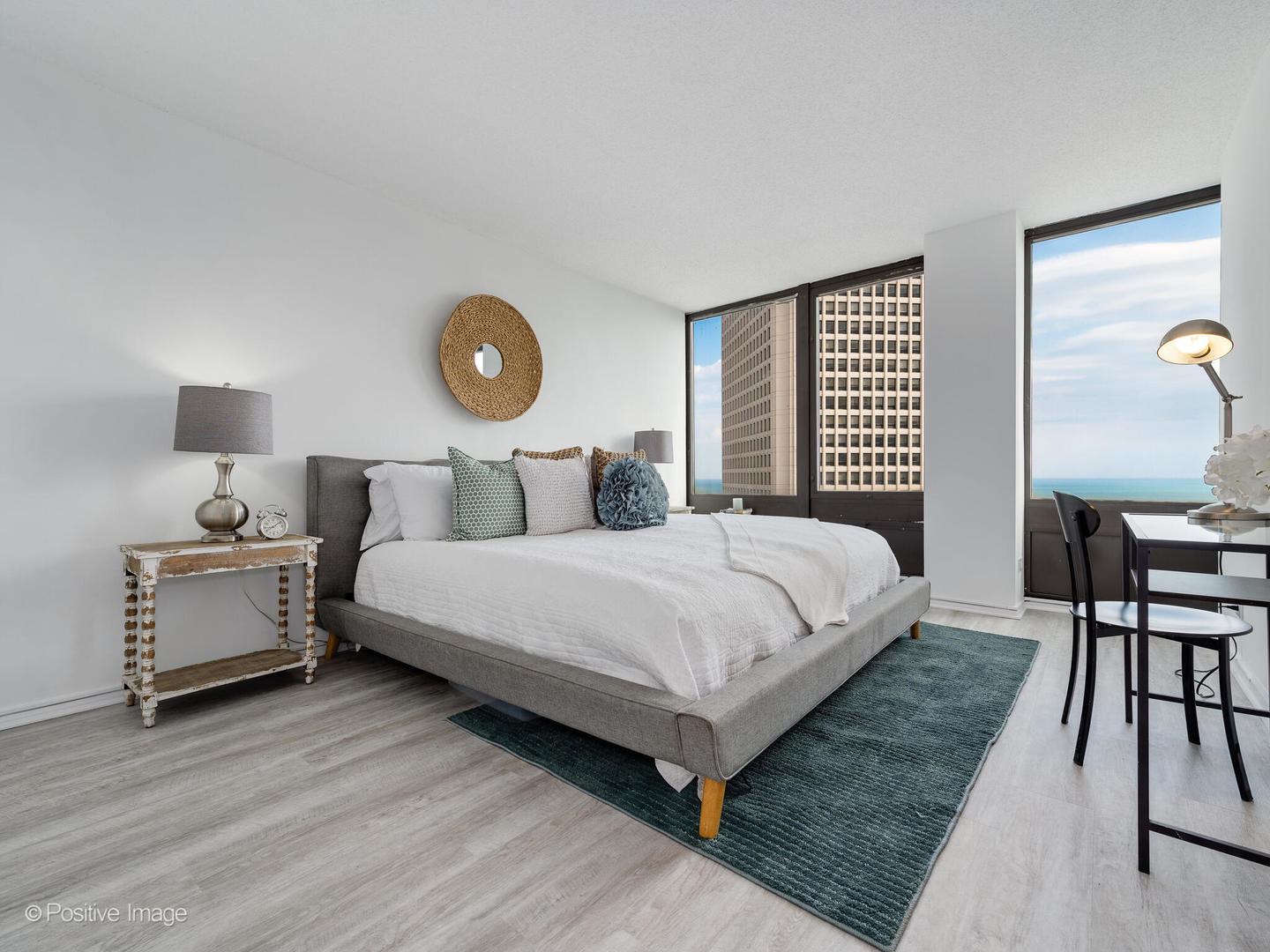 5320 North Sheridan Road, Unit 2206 Chicago, IL 60640 - Photo 11 of 20 a bedroom with a bed and a table