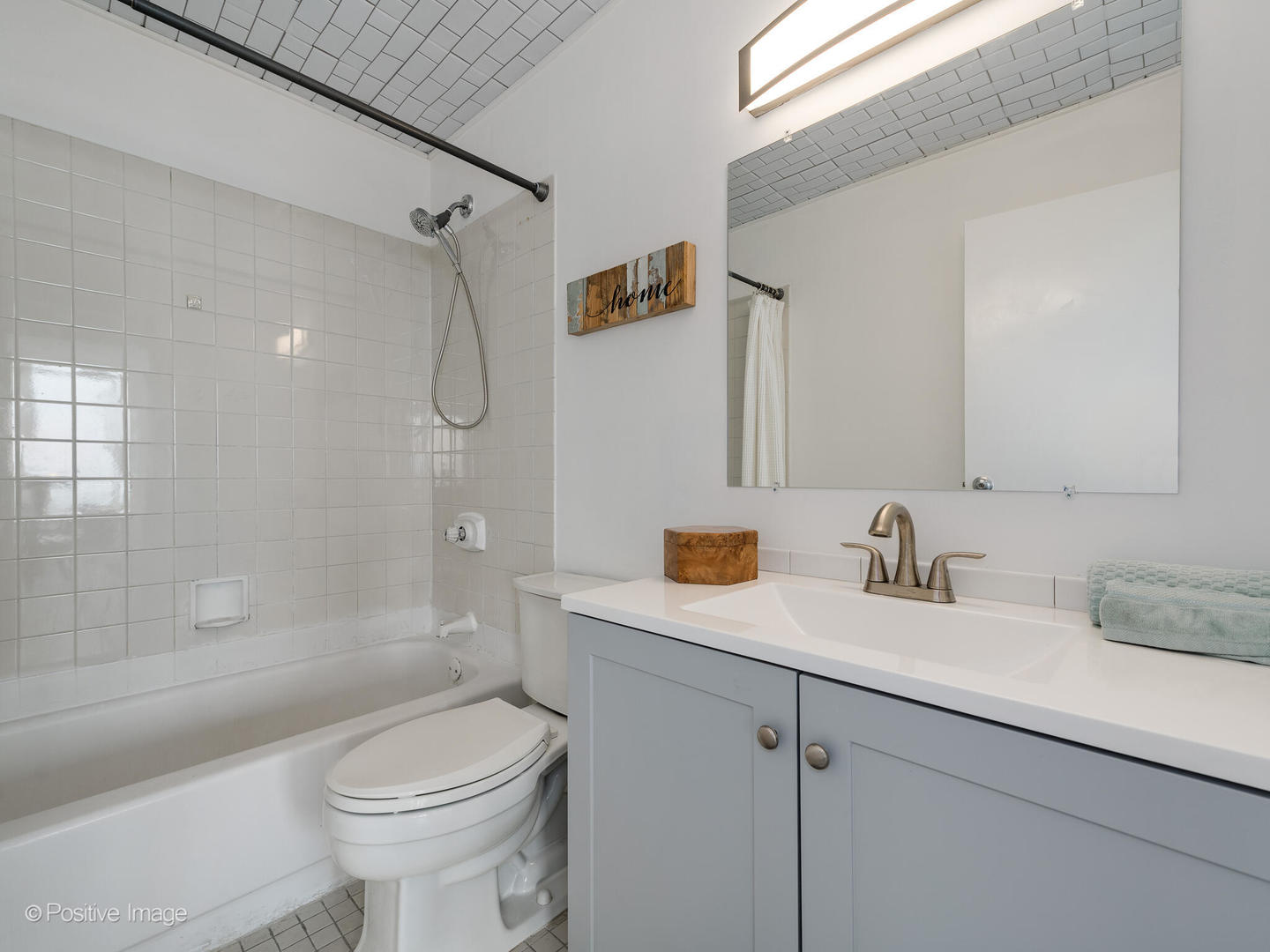 5320 North Sheridan Road, Unit 2206 Chicago, IL 60640 - Photo 12 of 20 a bathroom with a sink a toilet and shower