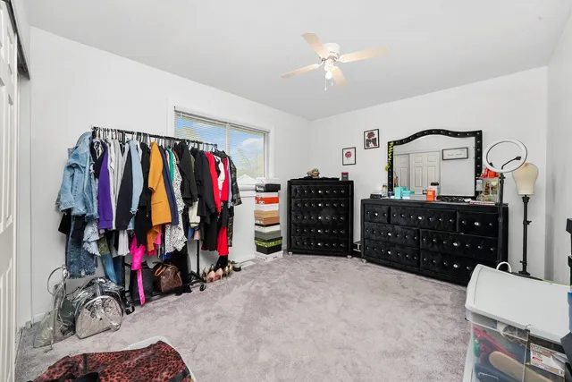 a view of walk in closet with clothes