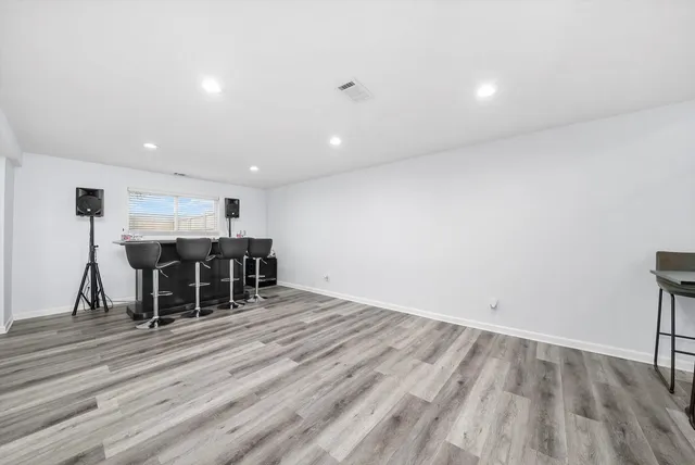 a view of a room with wooden floor and furniture