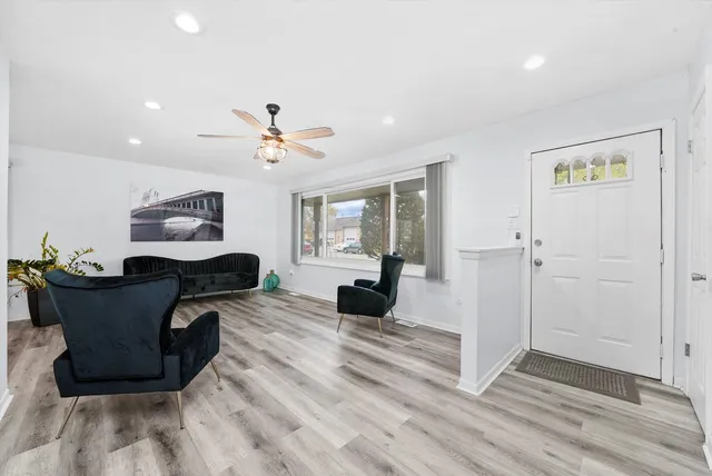 a living room with furniture and wooden floor