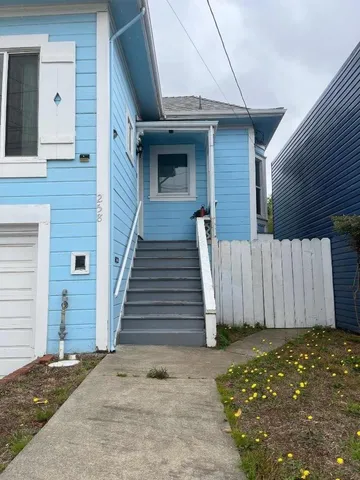 a view of a house with wooden fence