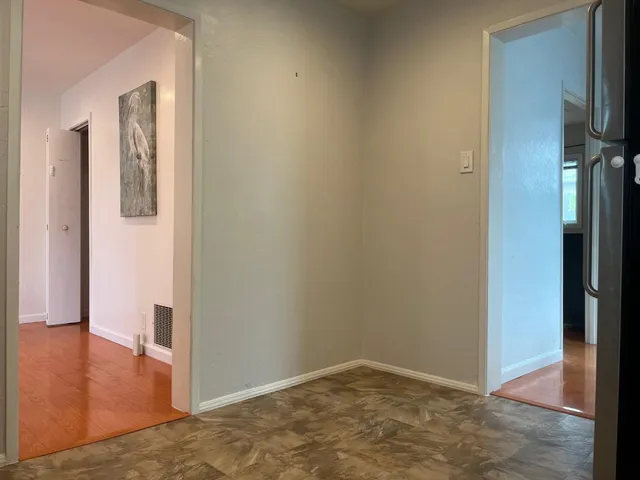 a view of a hallway with wooden floor