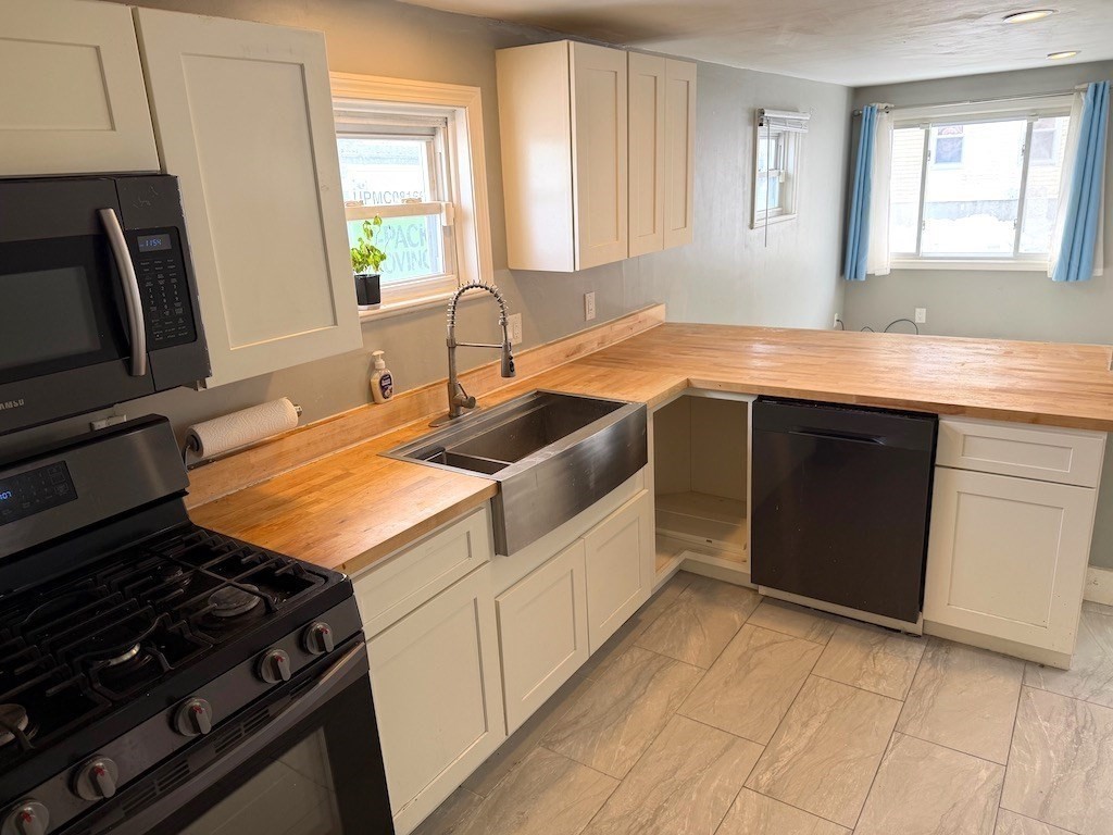 a kitchen with a sink stove and cabinets
