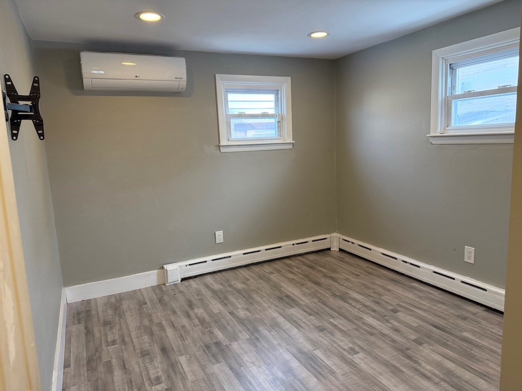 493 Rivet Street New Bedford, MA 02740 - Photo 13 of 20 wooden floor in an empty room with a window
