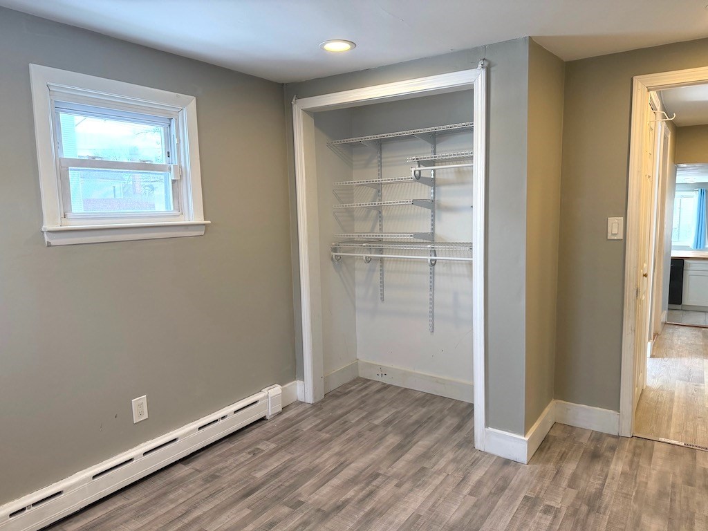 493 Rivet Street New Bedford, MA 02740 - Photo 14 of 20 an empty room with wooden floor closet and windows