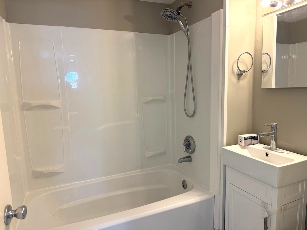 493 Rivet Street New Bedford, MA 02740 - Photo 15 of 20 a bathroom with a bathtub and a shower