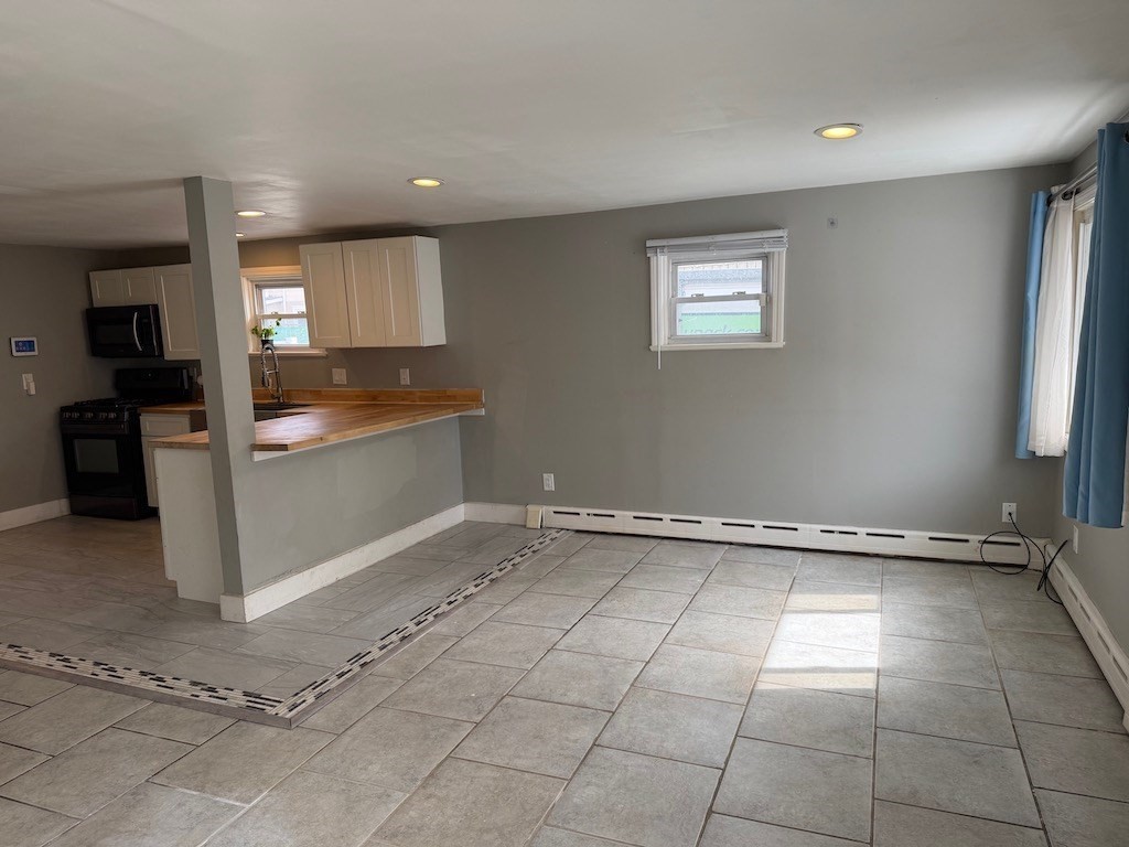 493 Rivet Street New Bedford, MA 02740 - Photo 5 of 20 a view of a kitchen with a sink and a window