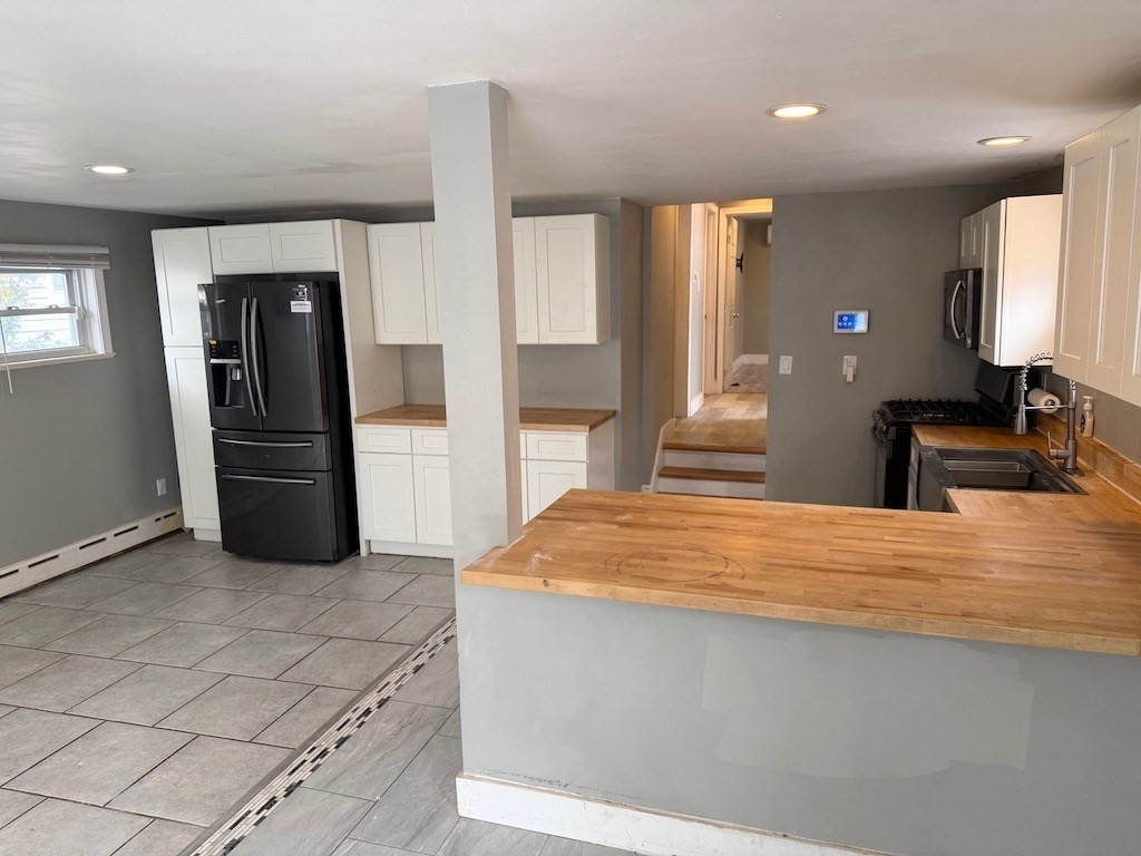 493 Rivet Street New Bedford, MA 02740 - Photo 7 of 20 a kitchen with stainless steel appliances kitchen island sink refrigerator and stove
