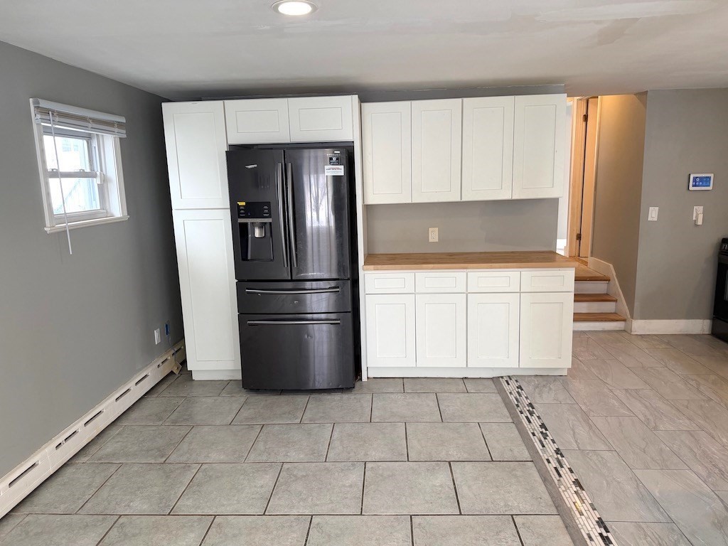 493 Rivet Street New Bedford, MA 02740 - Photo 8 of 20 a kitchen with granite countertop a refrigerator and a stove top oven