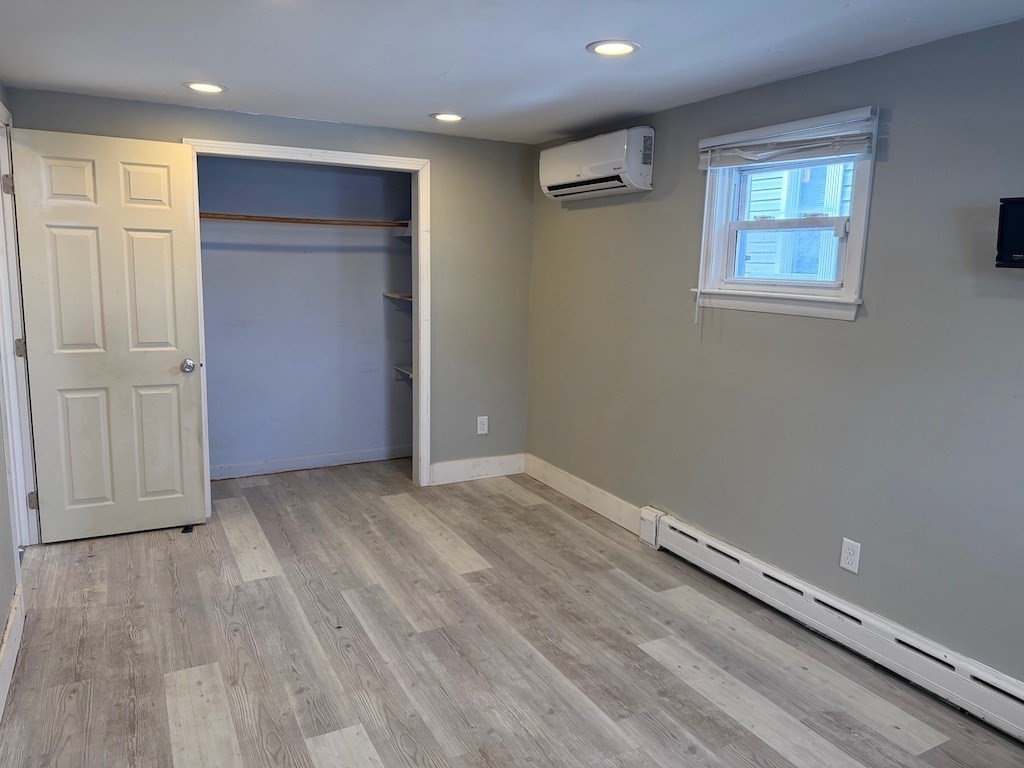 493 Rivet Street New Bedford, MA 02740 - Photo 10 of 20 an empty room with wooden floor and windows