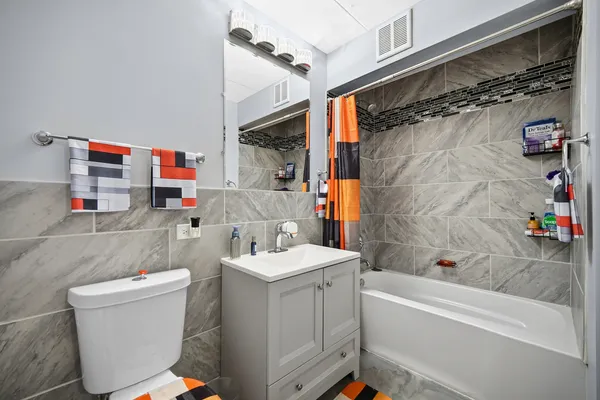 a bathroom with a sink a toilet and a shower curtain