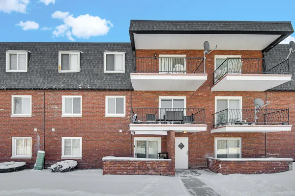 a front view of a residential apartment building with a yard