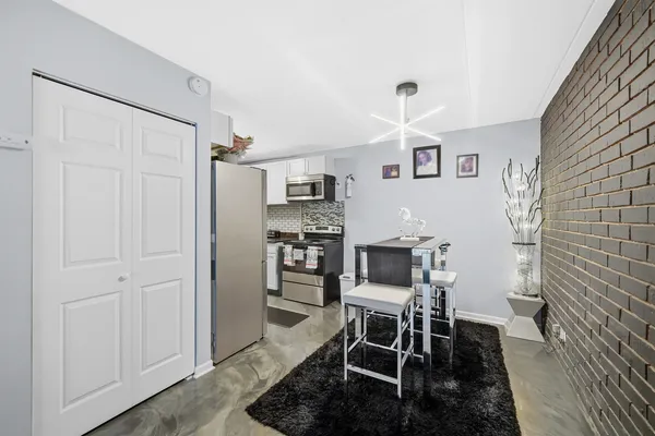 a dining room with furniture and window