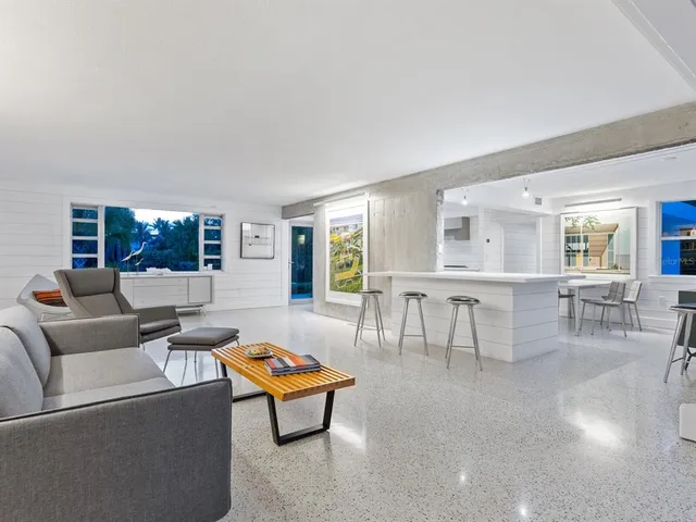 a bedroom with a bed chair and a large window