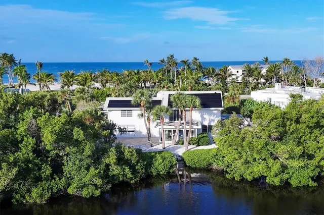 an aerial view of a house with a yard and garden