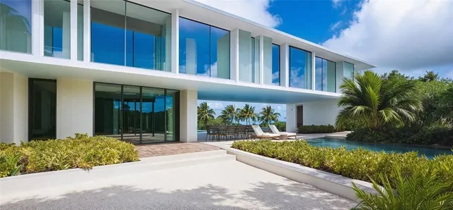 a view of a house with a yard and potted plants