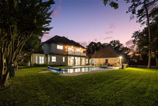a front view of a house with swimming pool and furniture