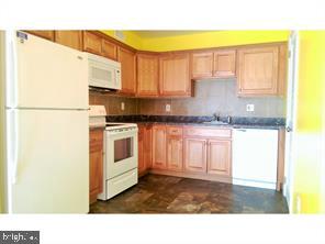 211 A Willow Turn, Unit 2 Mount Laurel, NJ 08054 - Photo 4 of 8 a kitchen with a sink a refrigerator and cabinets