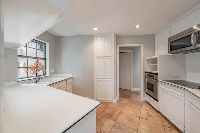 a kitchen with stainless steel appliances a stove sink and microwave