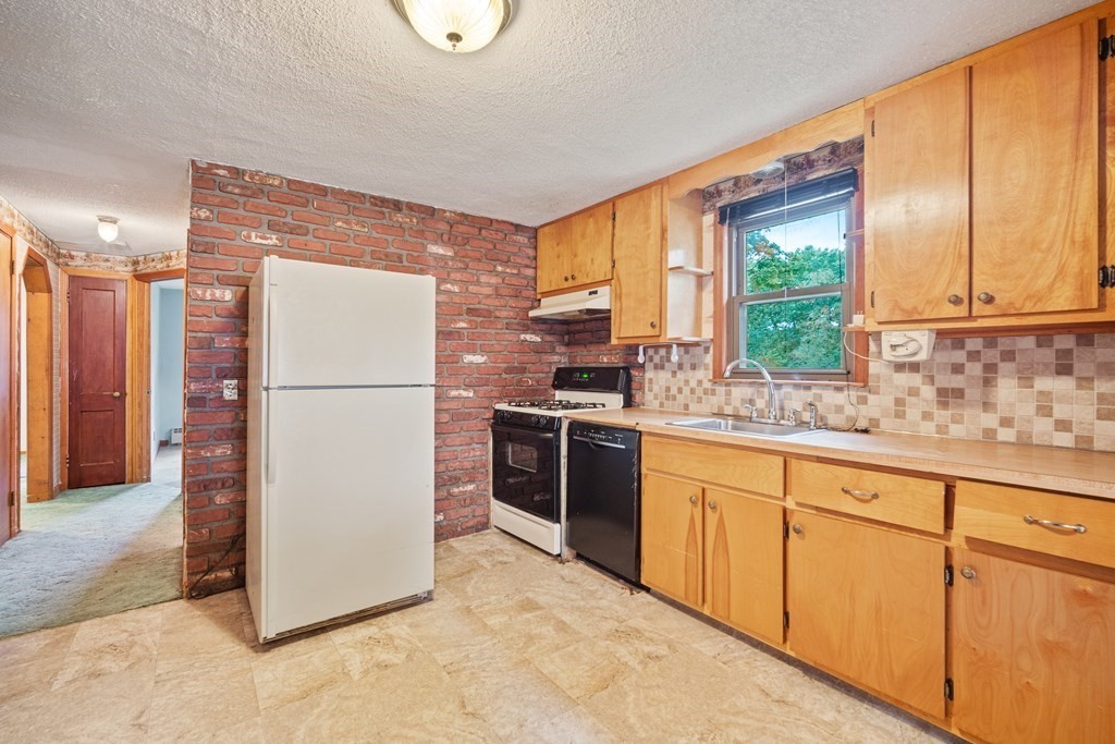 90 Oxford Road Holyoke, MA 01040 - Photo 6 of 29 a kitchen with appliances cabinets and a sink