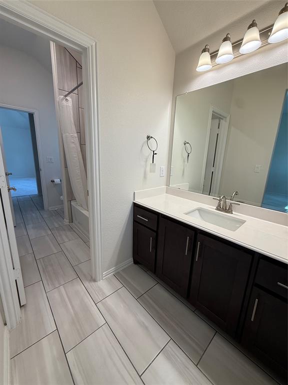 5212 Troupe Road McKinney, TX 75071 - Photo 22 of 38 Bathroom vanity featuring dark wood cabinetry with brushed nickel hardware, a white countertop, and an integrated sink with a chrome faucet