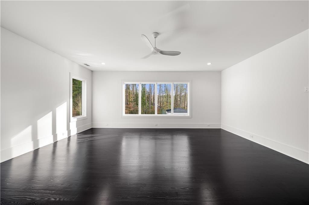 5211 Powers Ferry Road Northwest Sandy Springs, GA 30327 - Photo 92 of 106 a view of an empty room with wooden floor and a window