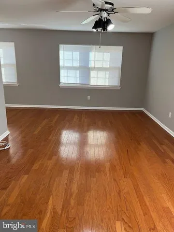 a view of wooden floor and windows in a room
