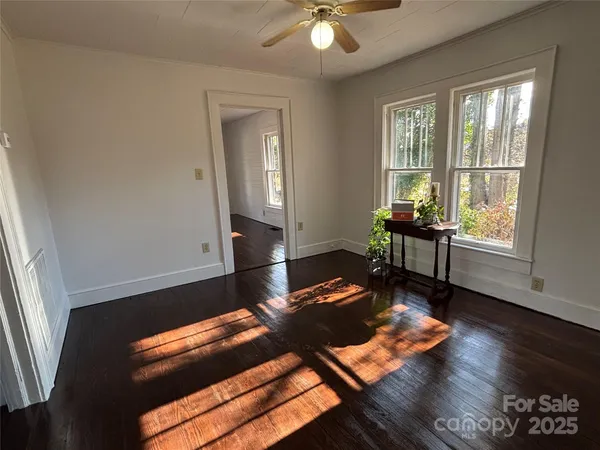 a hallway with chairs and a window