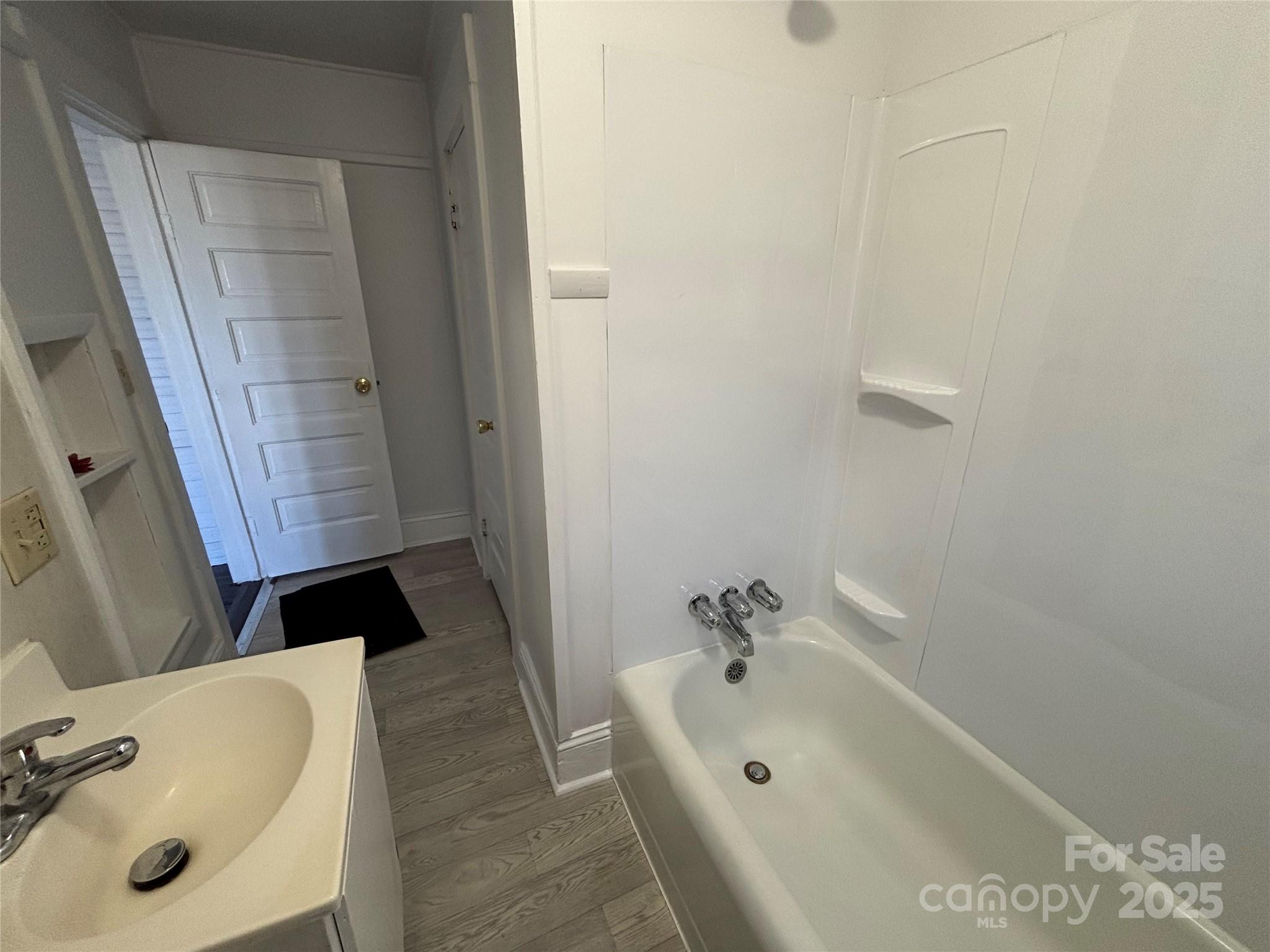142 26th Street Southwest Hickory, NC 28602 - Photo 10 of 11 a bathroom with a tub sink and mirror
