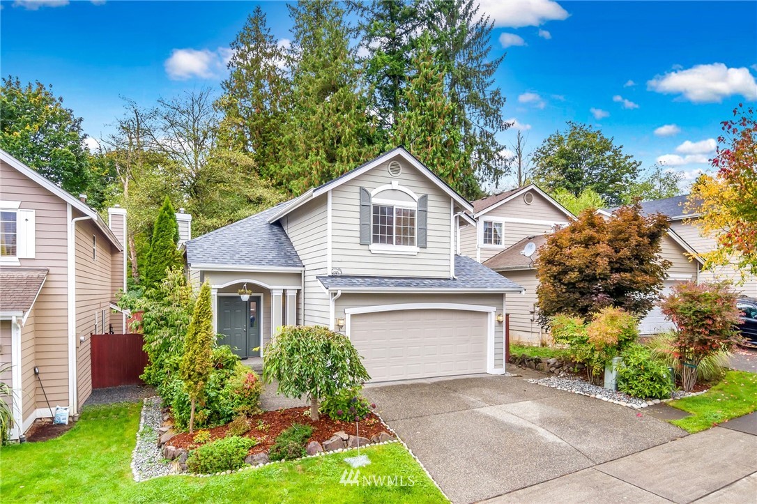 13402 Prospector Ridge Road Southeast Monroe, WA 98272 - Photo 1 of 30 a front view of a house with a yard and garage