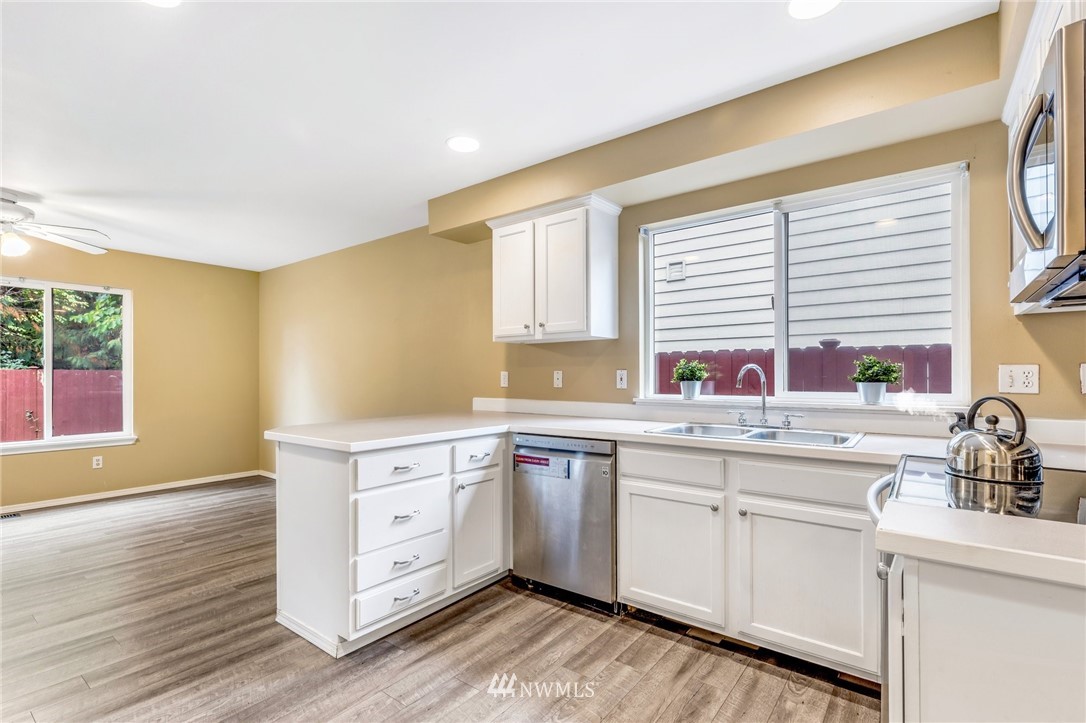 13402 Prospector Ridge Road Southeast Monroe, WA 98272 - Photo 12 of 30 a kitchen with white cabinets sink and window