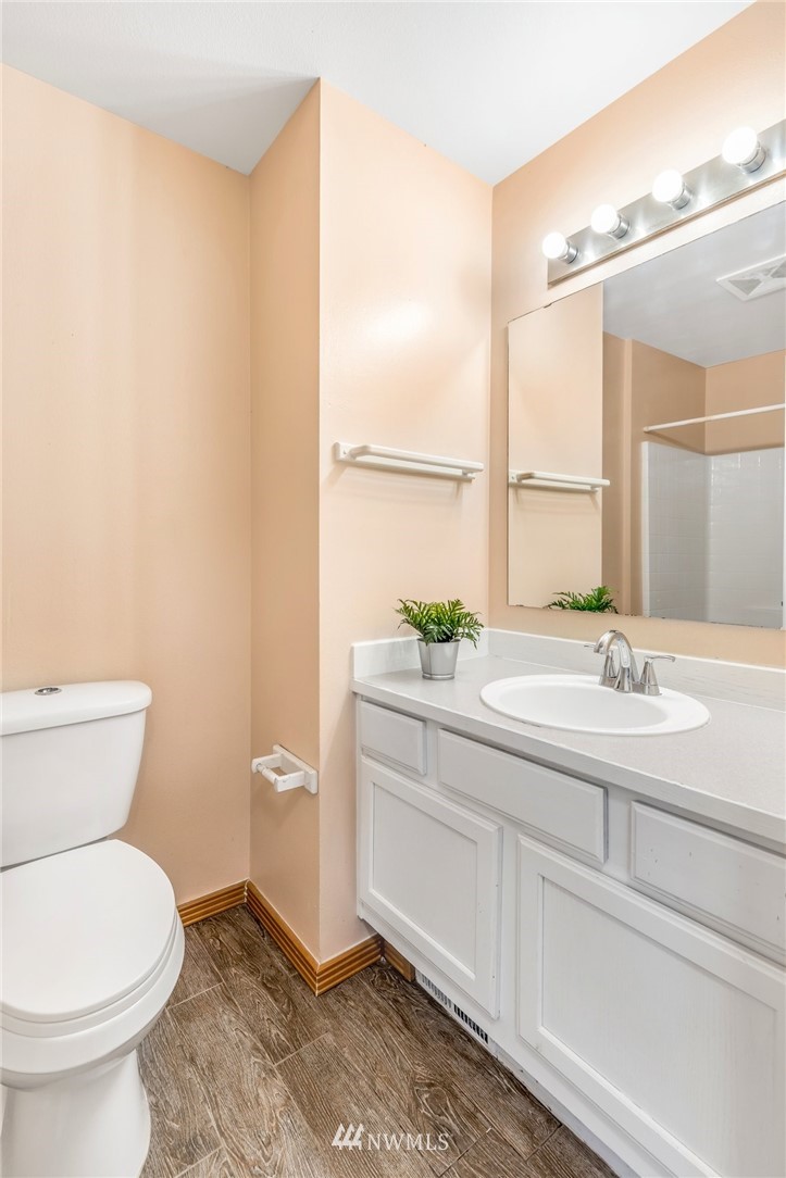 13402 Prospector Ridge Road Southeast Monroe, WA 98272 - Photo 17 of 30 a bathroom with a granite countertop toilet a sink and a mirror